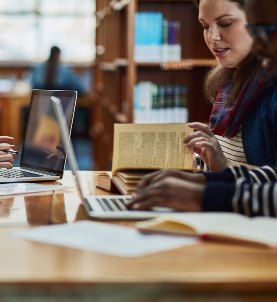 Shot of a group of university students working in the library at campus.